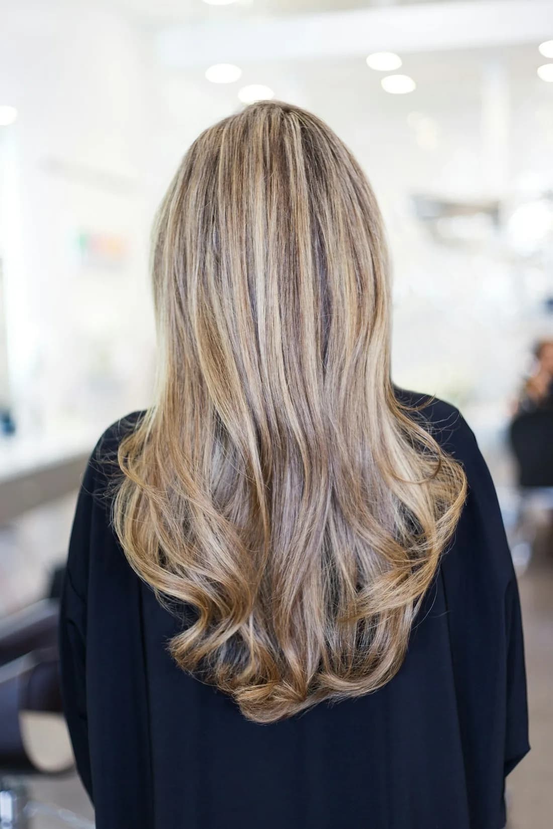 Finished balayage, long soft blonde waves seen from behind