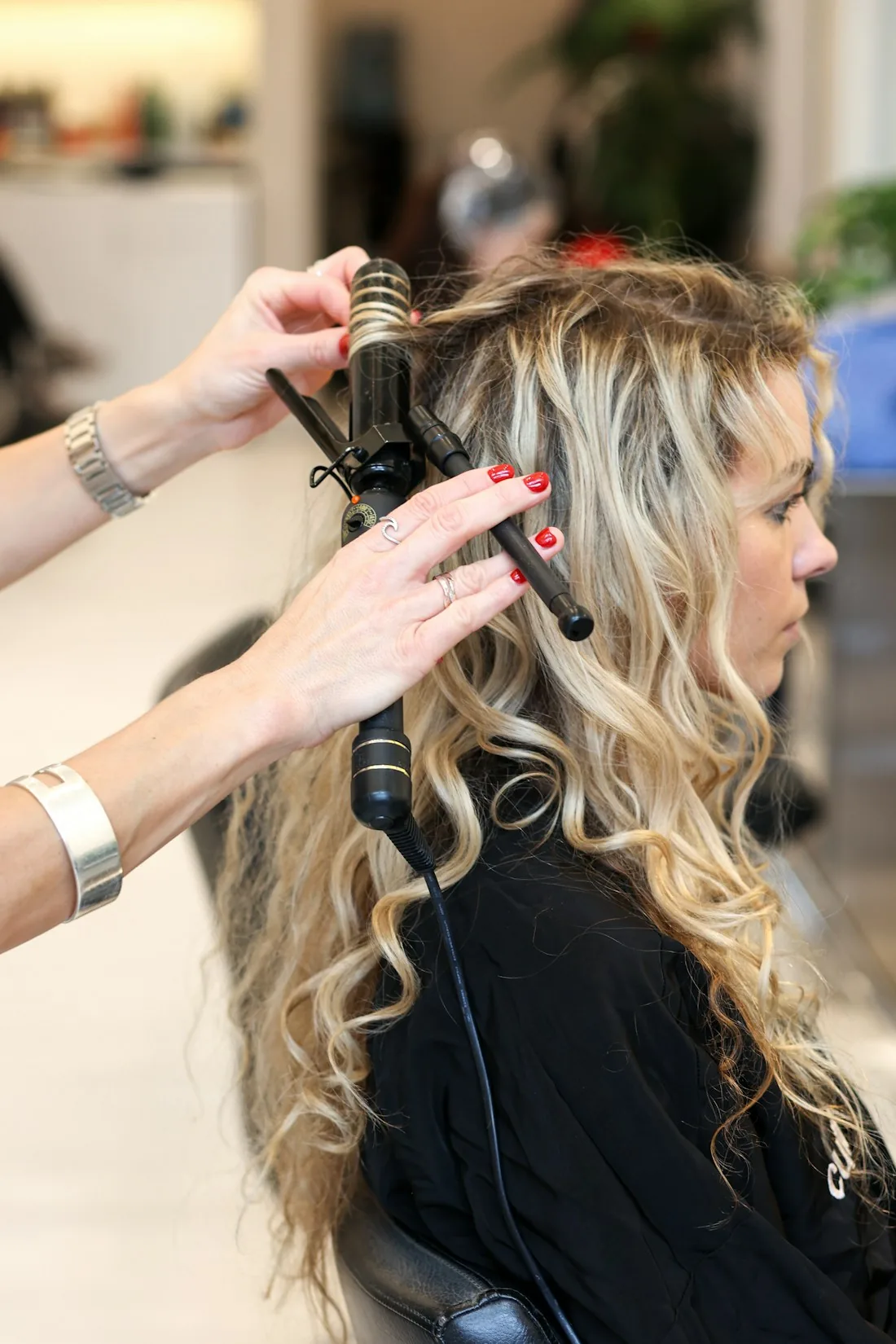 Curling iron mid-set, shaping loose curls chairside
